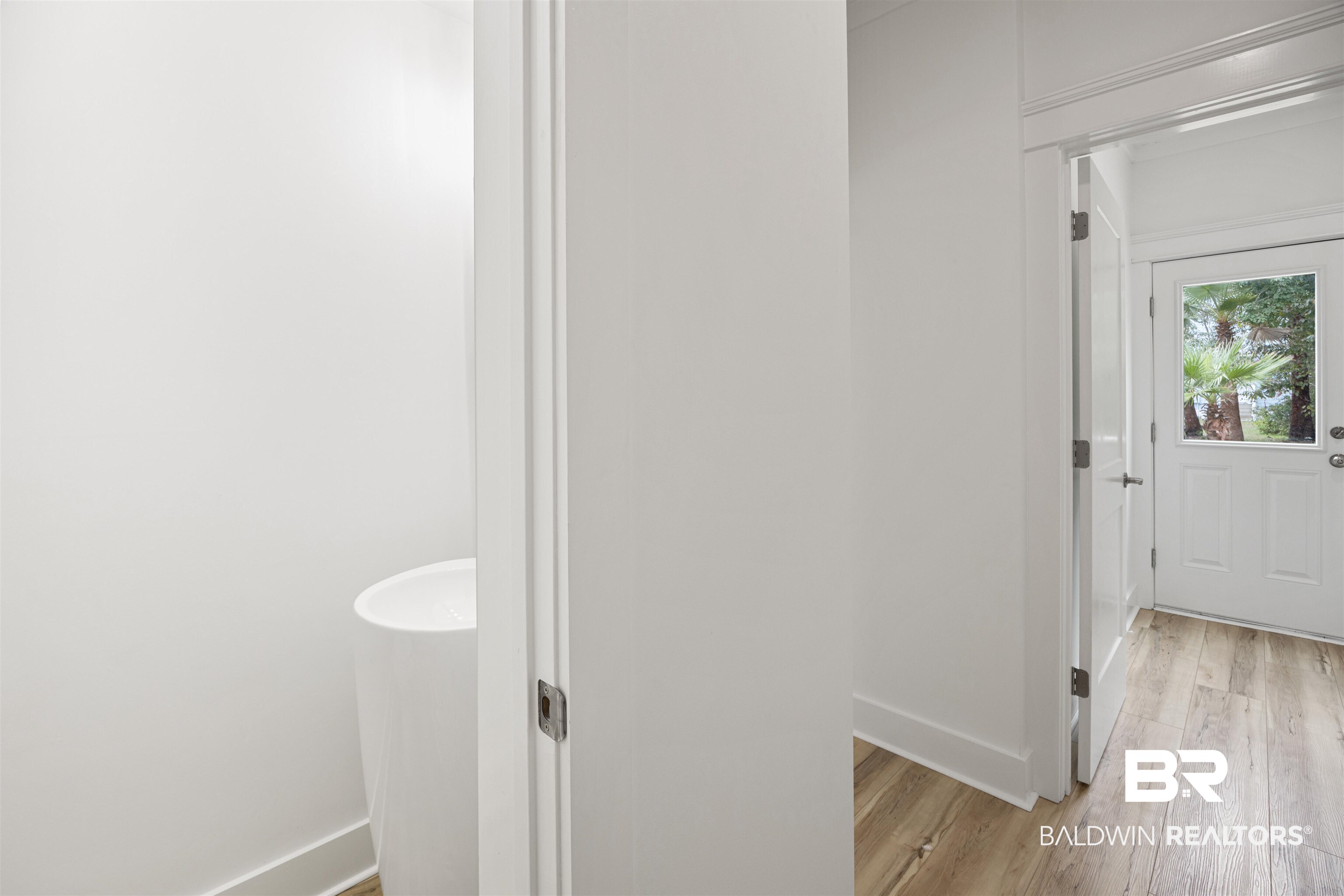 27591 Canal Road Orange Beach, AL 36561 - Photo 17 of 51 Bathroom featuring baseboards and light wood-style floors