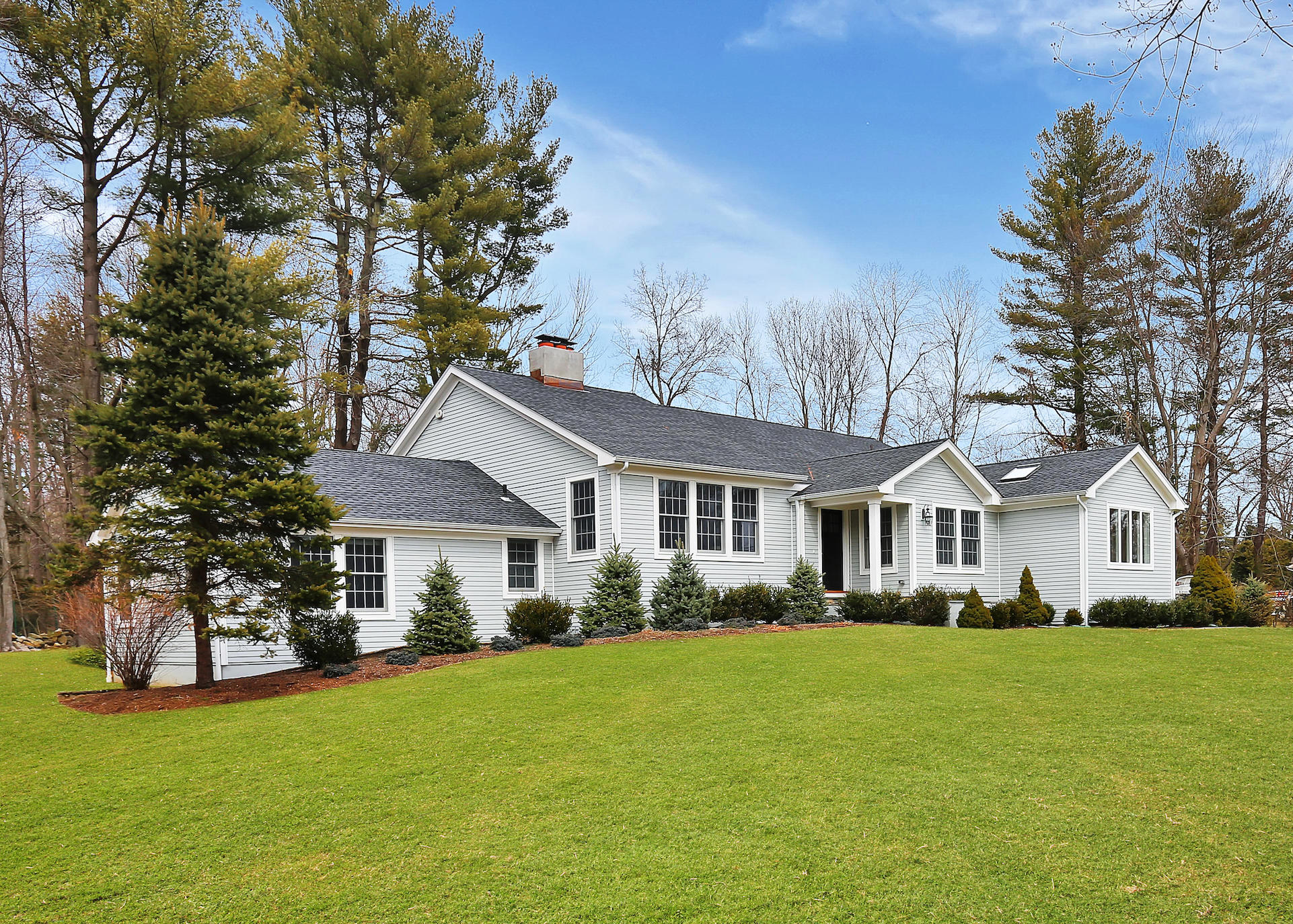 278 Davenport Ridge Road New Canaan, CT 06840 - Photo 1 of 31 a front view of a house with a garden