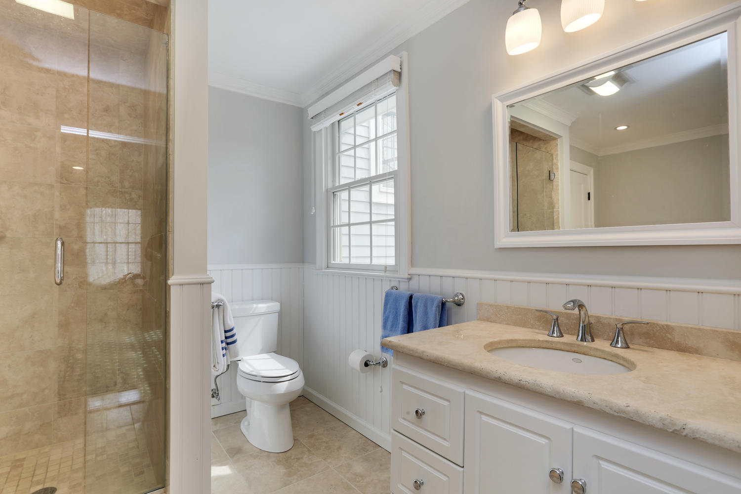278 Davenport Ridge Road New Canaan, CT 06840 - Photo 22 of 31 a bathroom with a granite countertop sink a toilet and a mirror