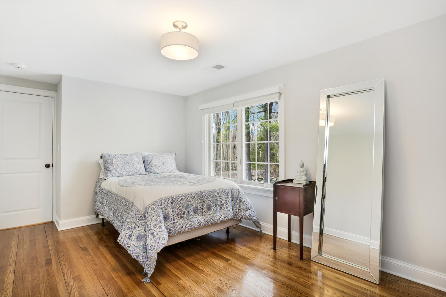 278 Davenport Ridge Road New Canaan, CT 06840 - Photo 23 of 31 a bedroom with a bed and wooden floor