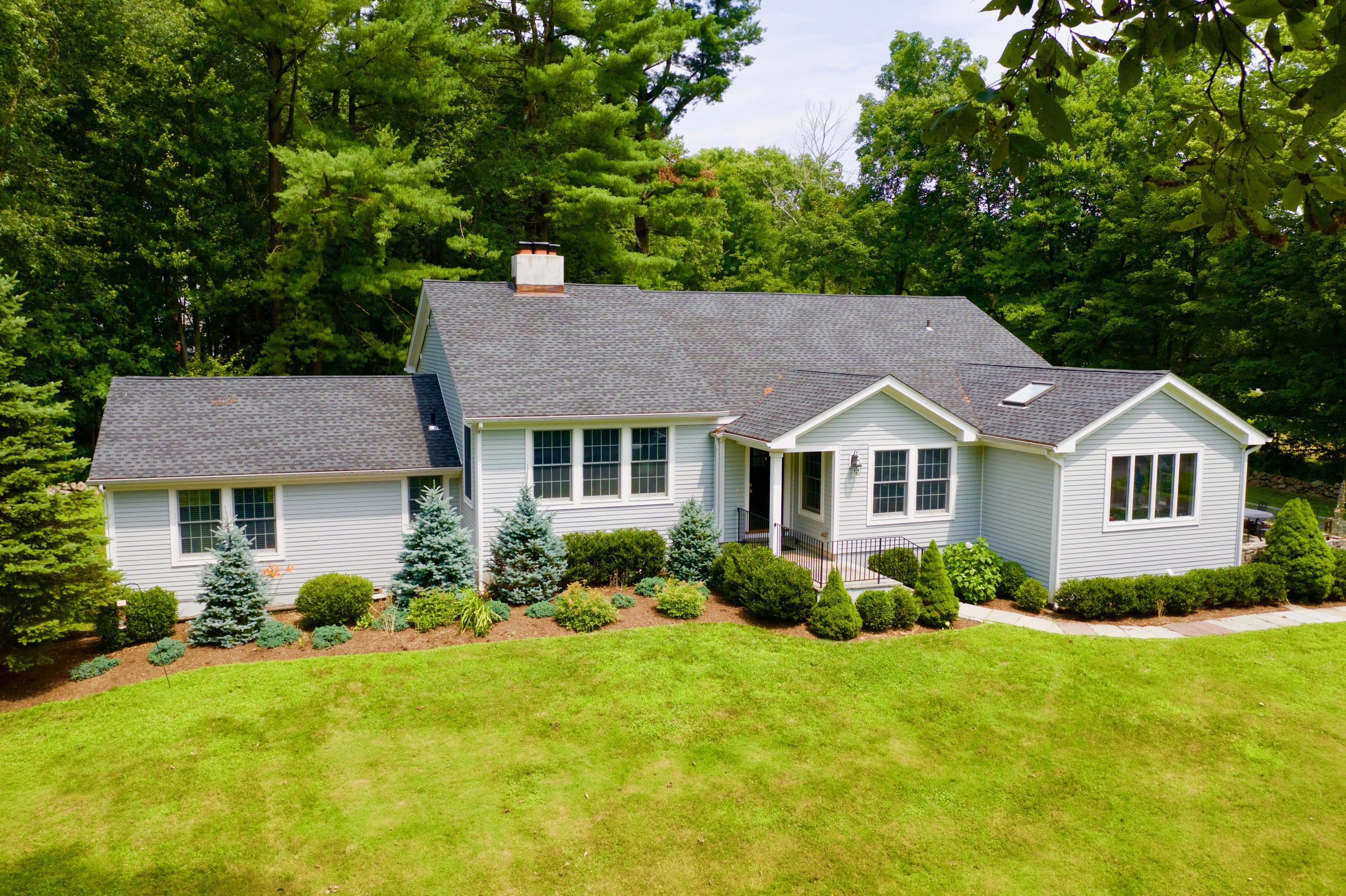 278 Davenport Ridge Road New Canaan, CT 06840 - Photo 27 of 31 a front view of a house with a yard