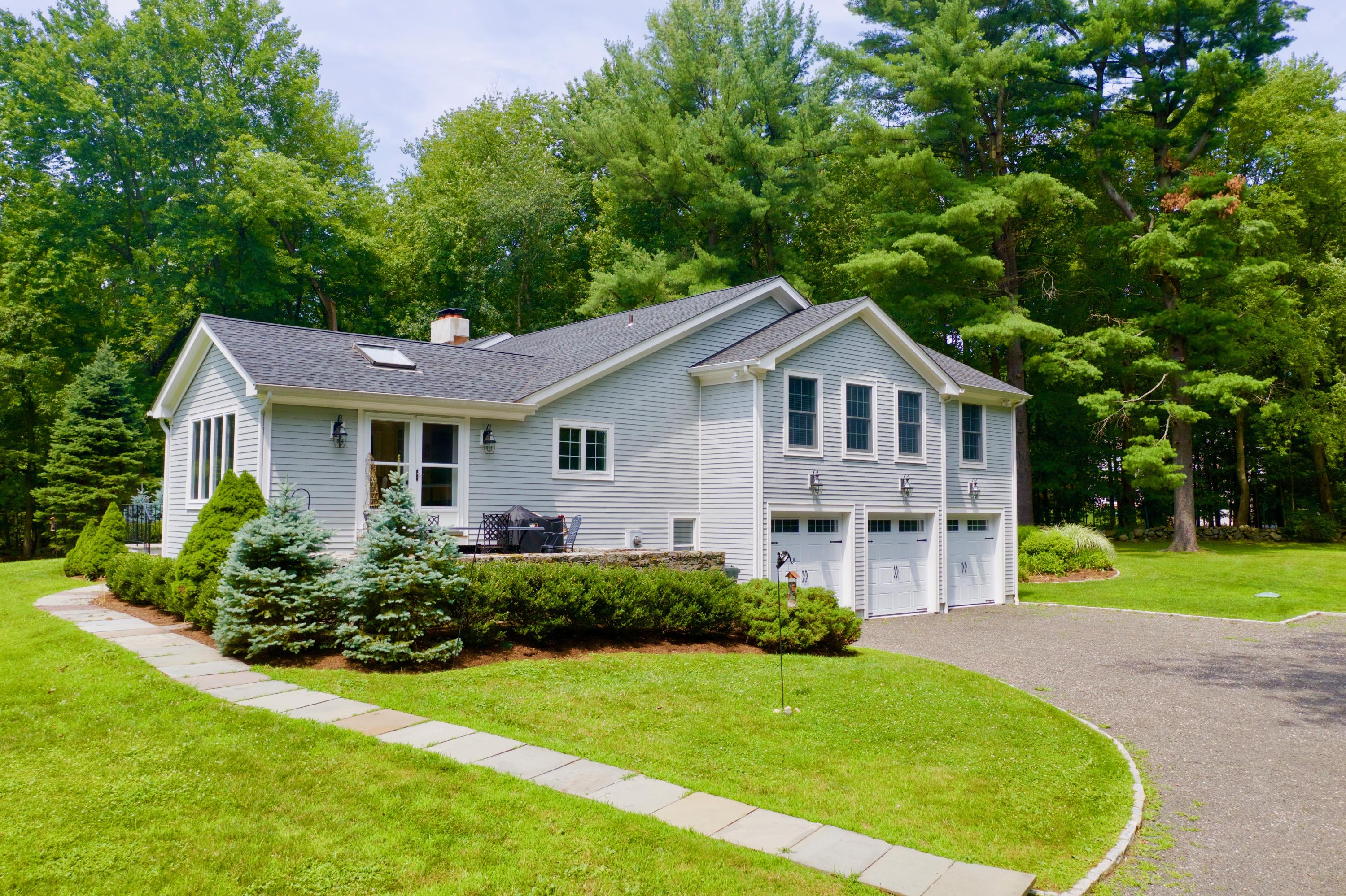 278 Davenport Ridge Road New Canaan, CT 06840 - Photo 28 of 31 a front view of a house with a yard