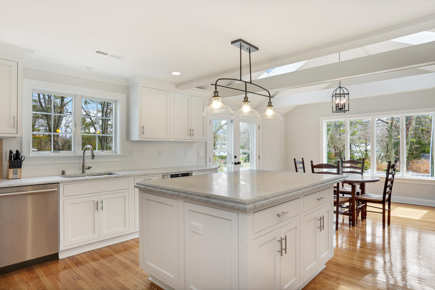 278 Davenport Ridge Road New Canaan, CT 06840 - Photo 7 of 31 a kitchen with a center island wooden floor cabinets and a chandelier
