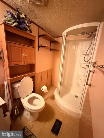 a bathroom with a toilet and a shower