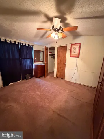 a view of a livingroom with a furniture and a ceiling fan