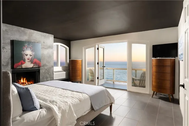 a bedroom with a large bed and a tv