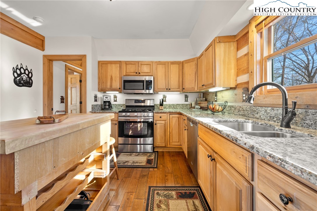 713 River Ridge Road Boone, NC 28607 - Photo 11 of 44 a kitchen with stainless steel appliances granite countertop a stove a sink and a microwave