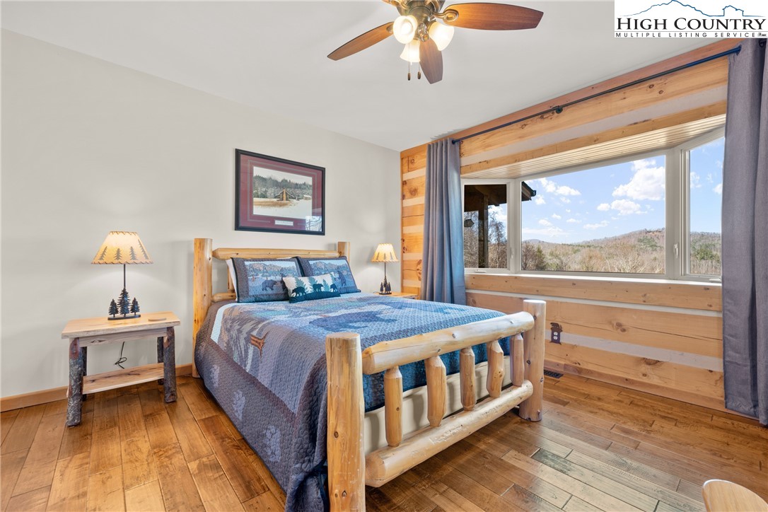 713 River Ridge Road Boone, NC 28607 - Photo 13 of 44 a bedroom with a large bed and a window