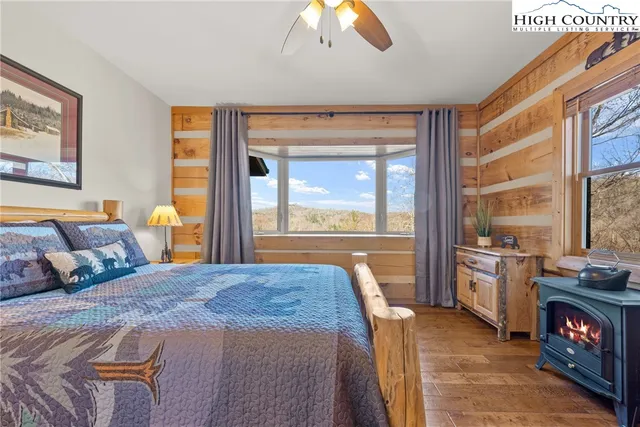 a bedroom with a large bed and a large window