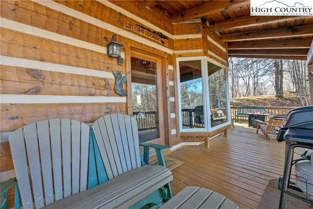 a view of a patio with wooden floor and outdoor seating