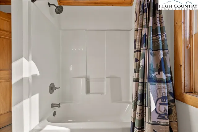 a bathroom with a bathtub and shower