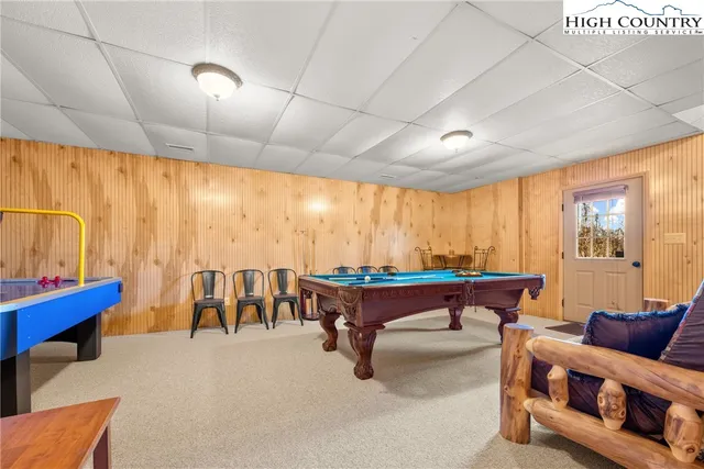 a living room with furniture a large window with kitchen view