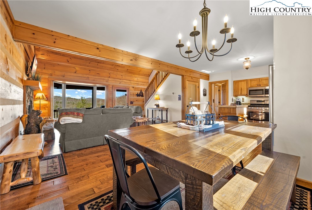 713 River Ridge Road Boone, NC 28607 - Photo 5 of 44 a view of a dining room with furniture a chandelier and wooden floor