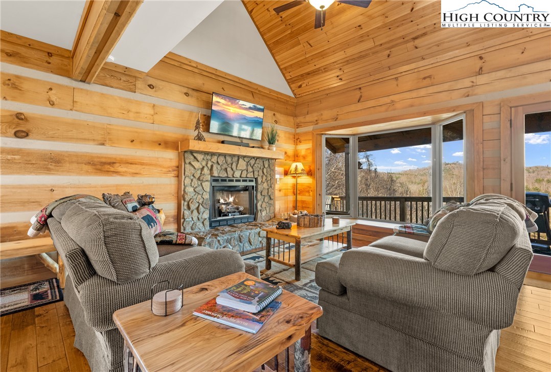 713 River Ridge Road Boone, NC 28607 - Photo 6 of 44 a living room with furniture a fireplace and a large window