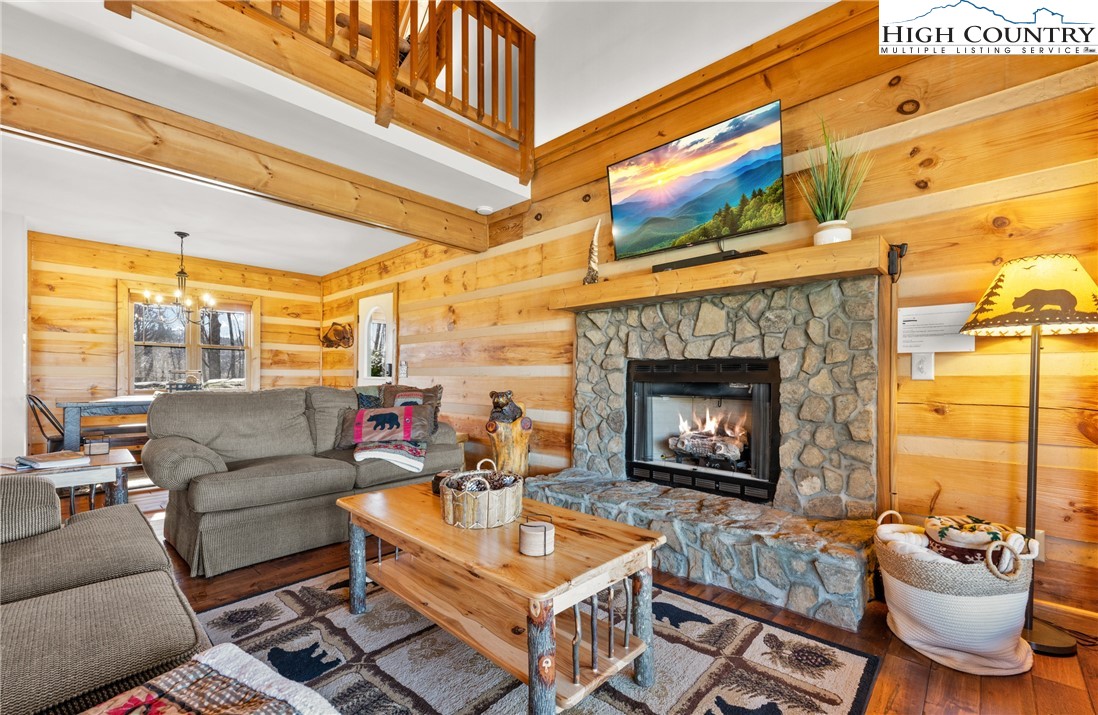 713 River Ridge Road Boone, NC 28607 - Photo 7 of 44 a living room with furniture a fireplace and a flat screen tv