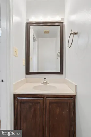 a bathroom with a sink vanity and a mirror