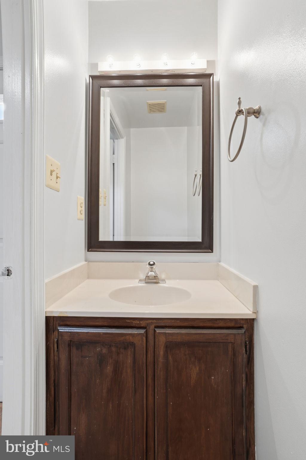 7923 Pebble Brook Court Springfield, VA 22153 - Photo 12 of 34 a bathroom with a sink vanity and a mirror