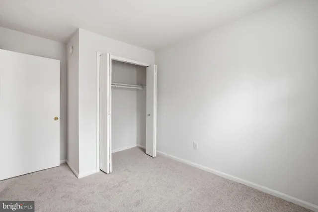 a view of an empty room and closet