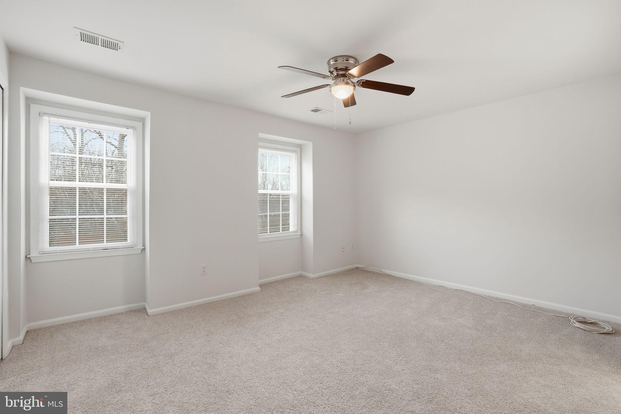 7923 Pebble Brook Court Springfield, VA 22153 - Photo 23 of 34 an empty room with windows and fan