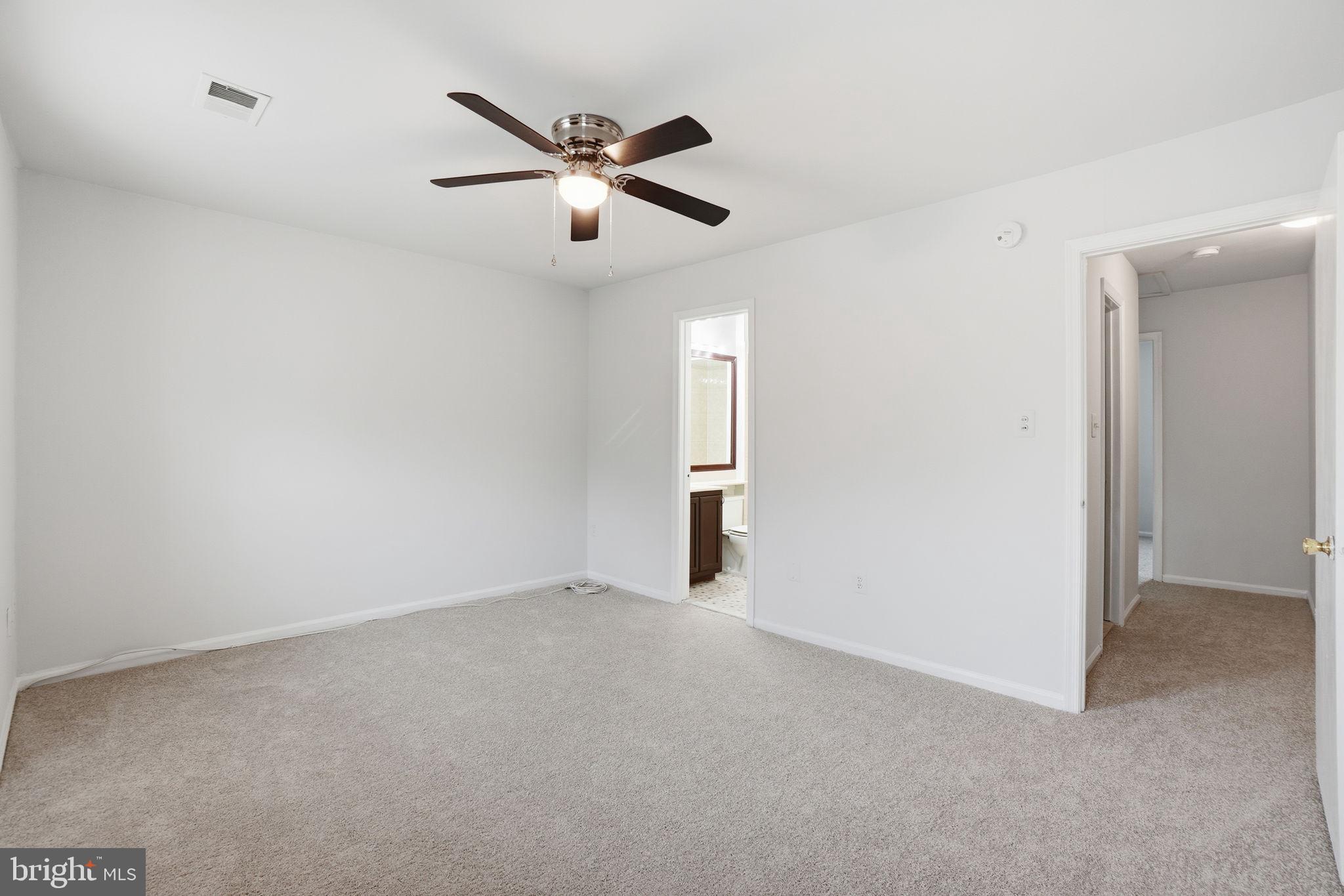 7923 Pebble Brook Court Springfield, VA 22153 - Photo 24 of 34 an empty room with chandelier fan and windows