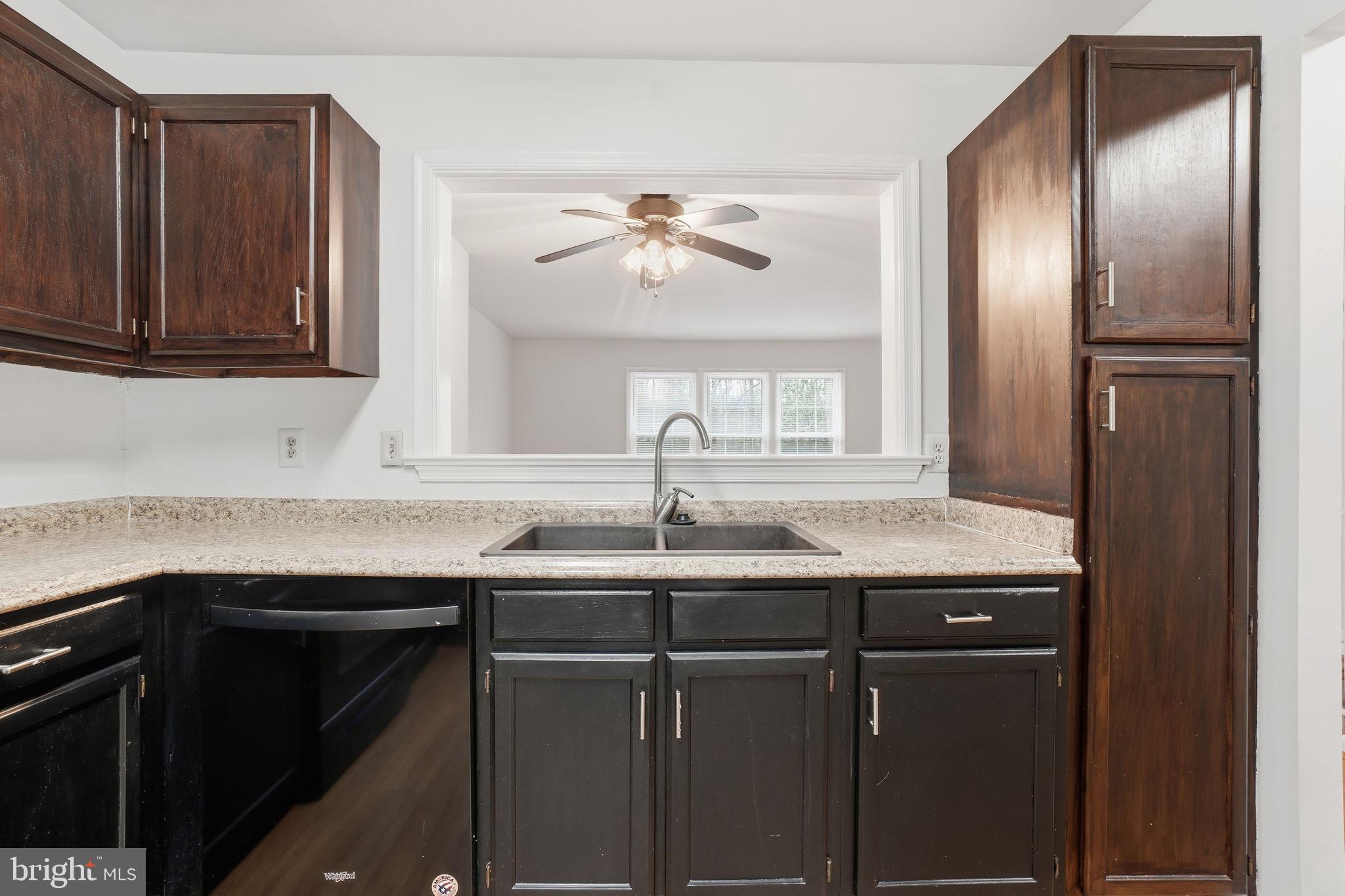 7923 Pebble Brook Court Springfield, VA 22153 - Photo 6 of 34 a kitchen with granite countertop a sink stainless steel appliances and cabinets