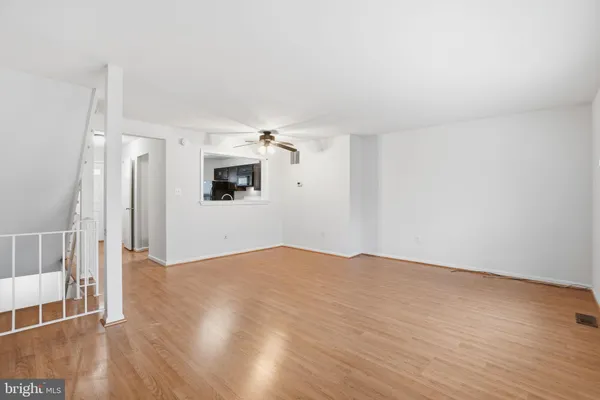 a view of empty room with wooden floor and fireplace