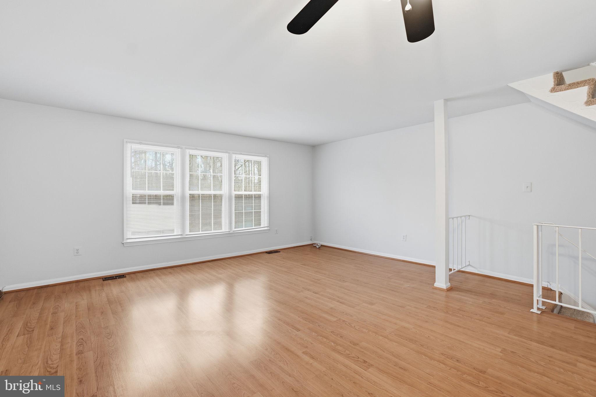 7923 Pebble Brook Court Springfield, VA 22153 - Photo 10 of 34 a view of an empty room with wooden floor and windows
