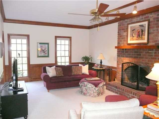 Welcoming family room with raised wood buring fireplace. 9 ft smoorth ceiling throughout the downstairs, Den/Family/Great Room