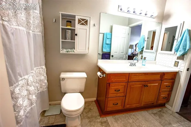 a bathroom with a toilet sink and mirror