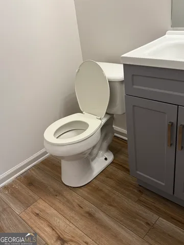 a view of a room with wooden floor fireplace and windows