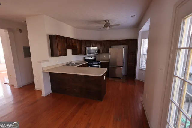 en empty room with windows and ceiling fan view