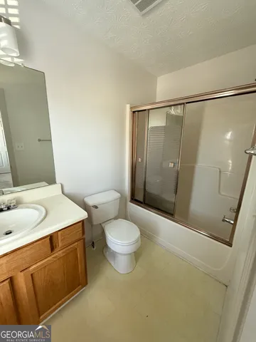 a view of an empty room and a window