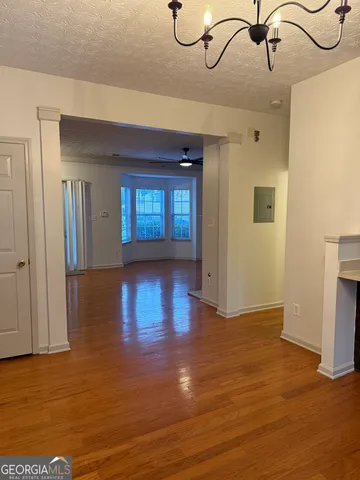a view of an empty room with a fireplace and a window