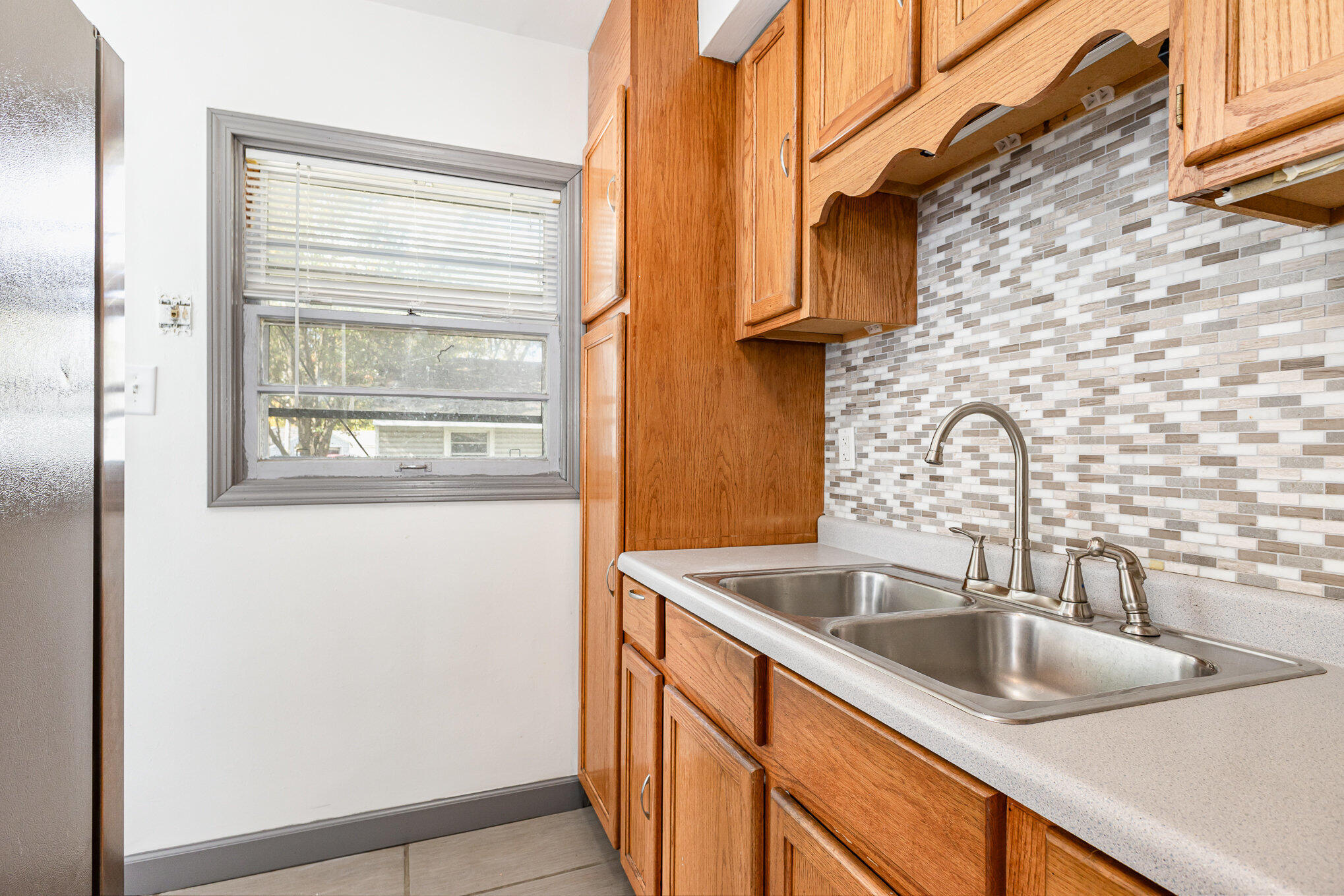 7536 Harrison Avenue Hammond, IN 46324 - Photo 4 of 16 a bathroom with a sink and a window
