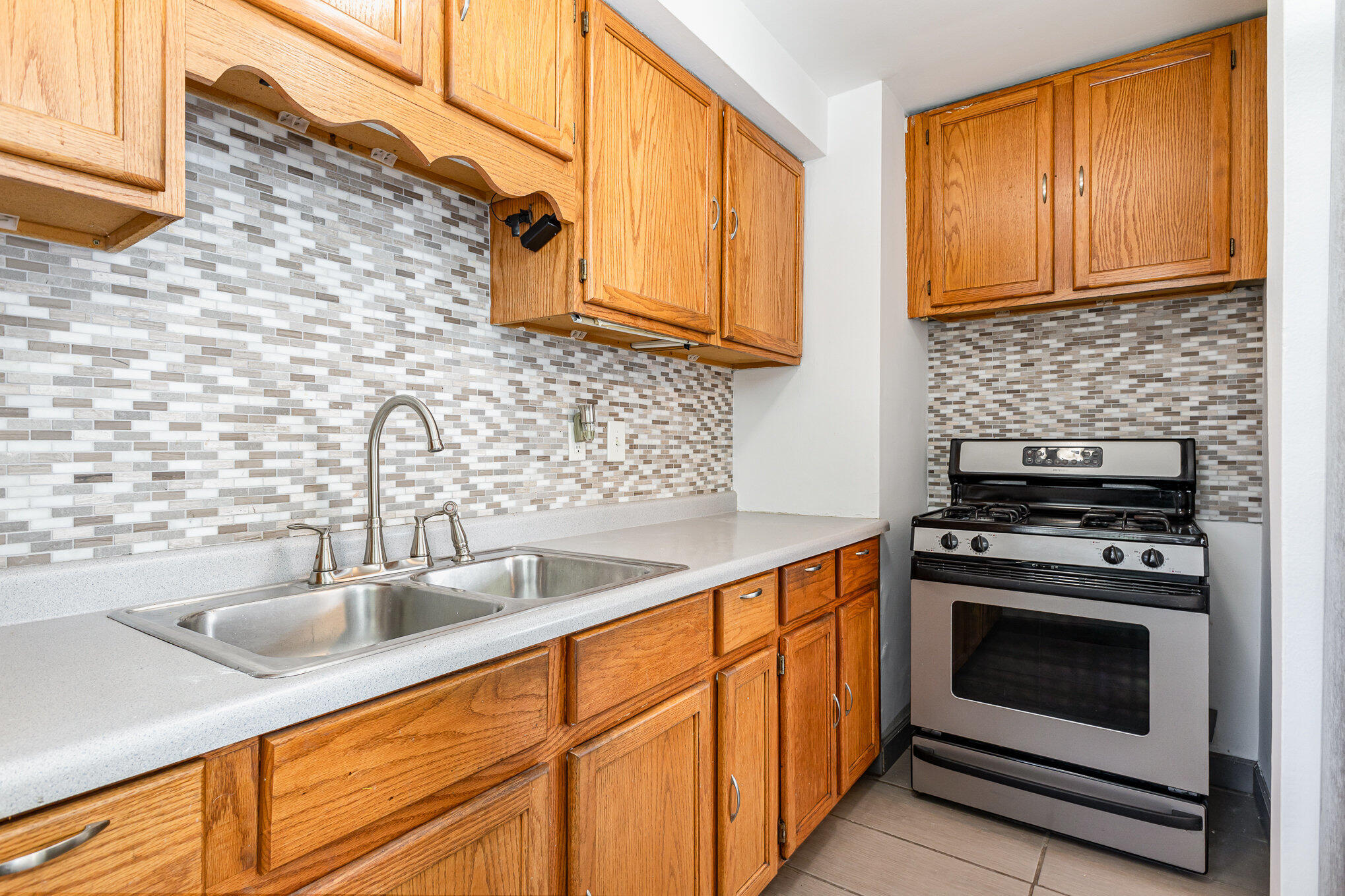 7536 Harrison Avenue Hammond, IN 46324 - Photo 5 of 16 a kitchen with stainless steel appliances granite countertop a sink a stove and cabinets