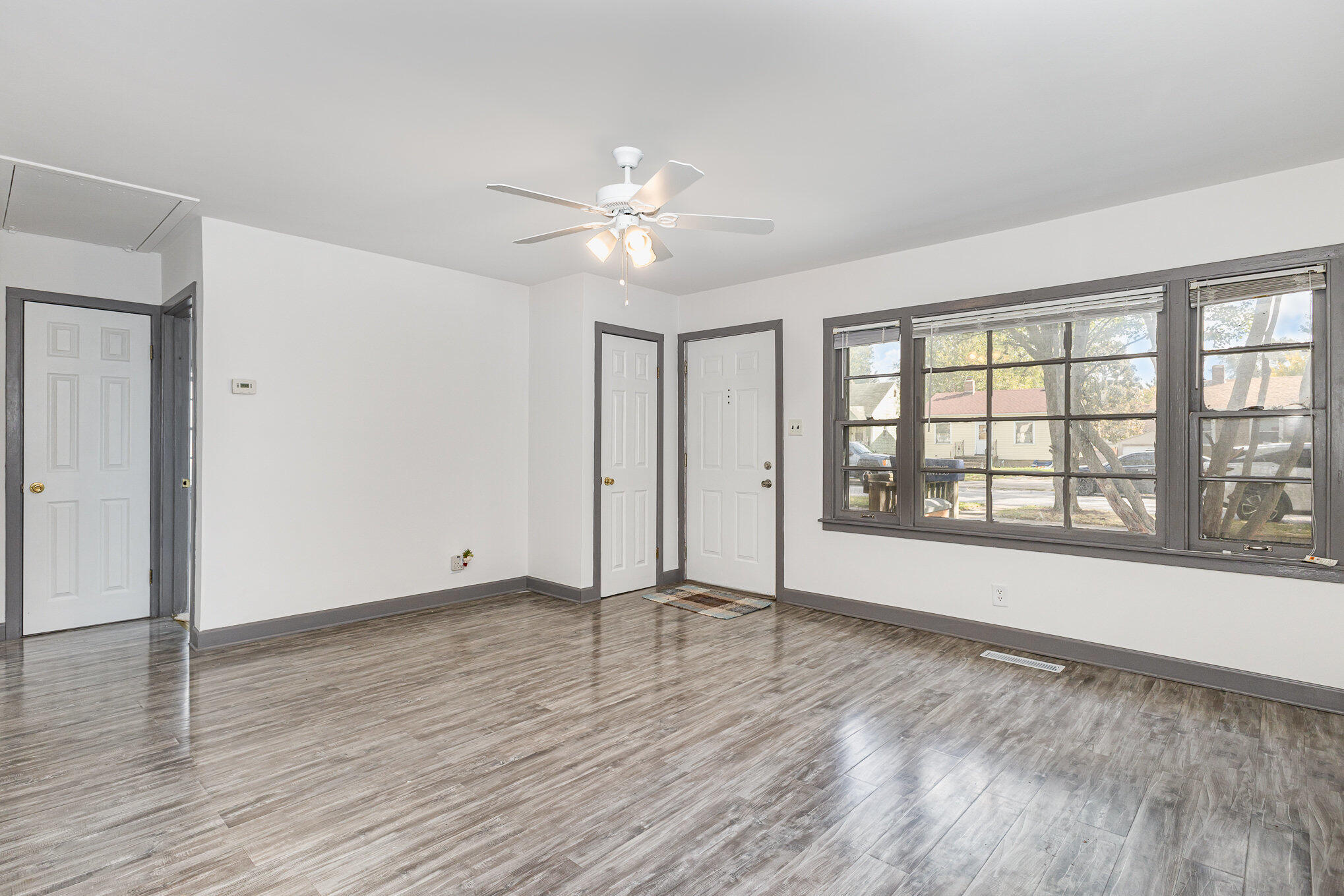 7536 Harrison Avenue Hammond, IN 46324 - Photo 6 of 16 a view of an empty room with window and wooden floor