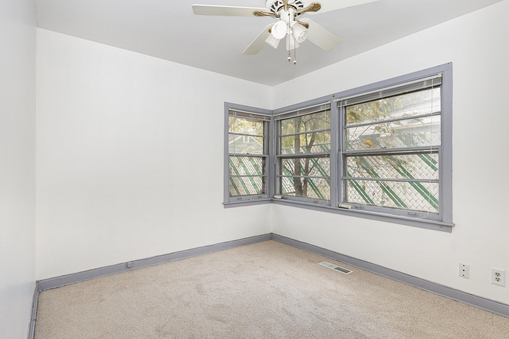 7536 Harrison Avenue Hammond, IN 46324 - Photo 9 of 16 an empty room with windows and chandelier fan