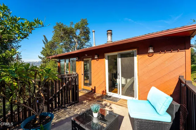 a kitchen with stainless steel appliances a dining table chairs and a refrigerator