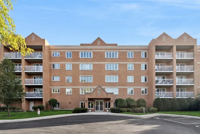 a front view of a building with a yard and a garage