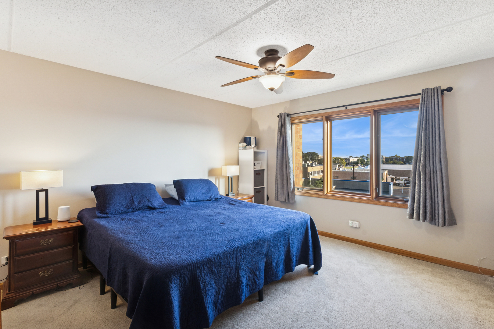 7450 North Waukegan Road, Unit 404 Niles, IL 60714 - Photo 2 of 21 a spacious bedroom with a bed and a large window