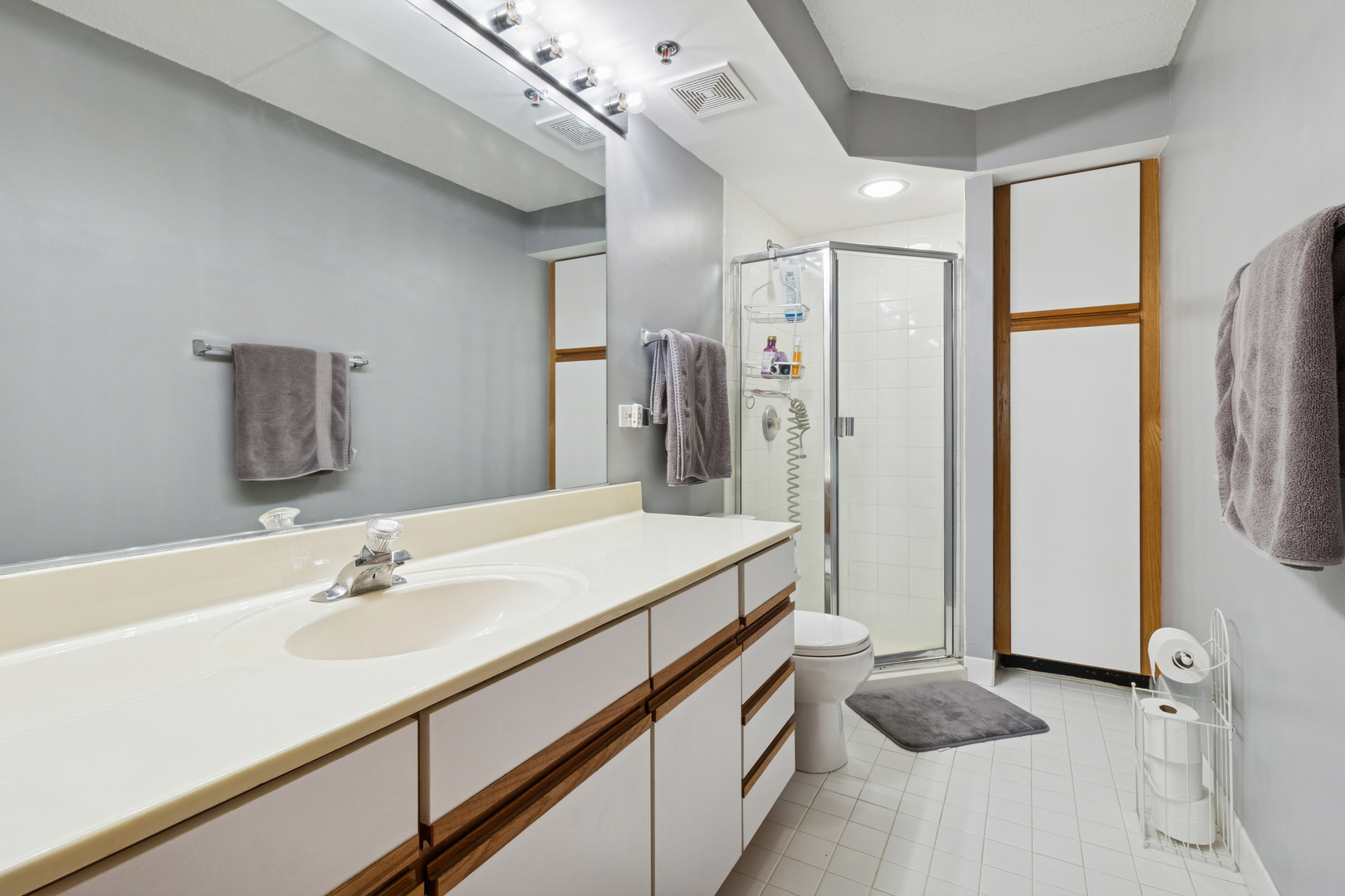 7450 North Waukegan Road, Unit 404 Niles, IL 60714 - Photo 5 of 21 a bathroom with a sink double vanity and a shower