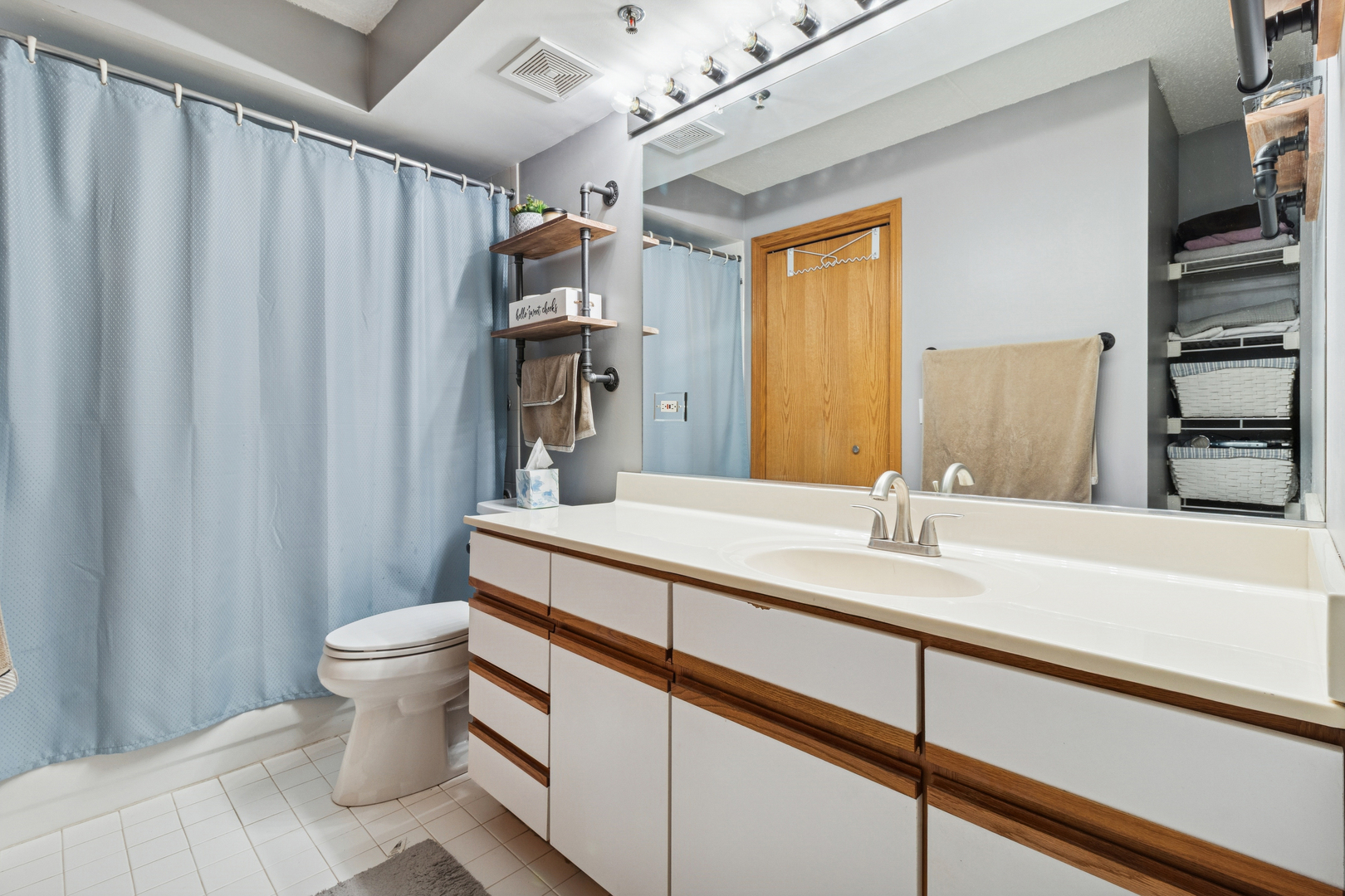 7450 North Waukegan Road, Unit 404 Niles, IL 60714 - Photo 6 of 21 a bathroom with a sink a toilet and shower