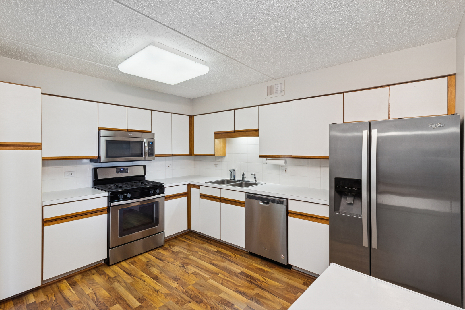 7450 North Waukegan Road, Unit 404 Niles, IL 60714 - Photo 9 of 21 a kitchen with stainless steel appliances granite countertop a refrigerator sink and stove