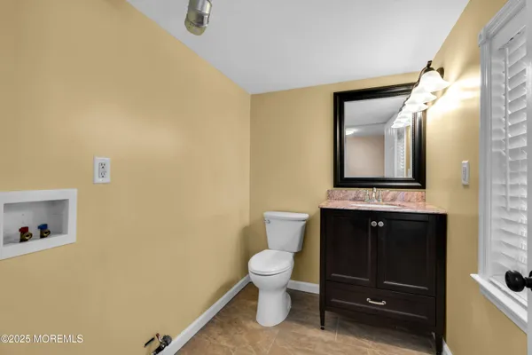 a bathroom with a toilet sink and mirror