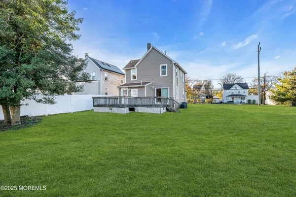 a view of a house with a big yard and garden