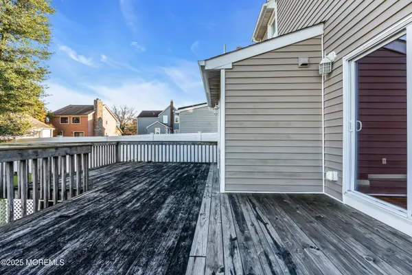 a view of a wooden balcony with wooden floor and fence