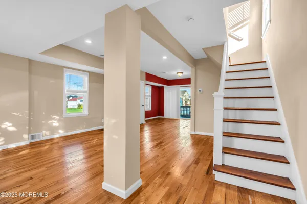 a view of entryway with wooden floor and stairs