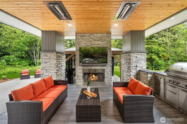 a outdoor space with patio the couches and a fireplace