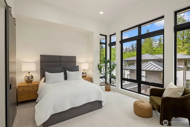 a bedroom with bed and glass window