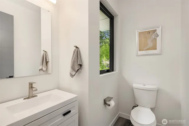 a bathroom with a toilet sink and mirror